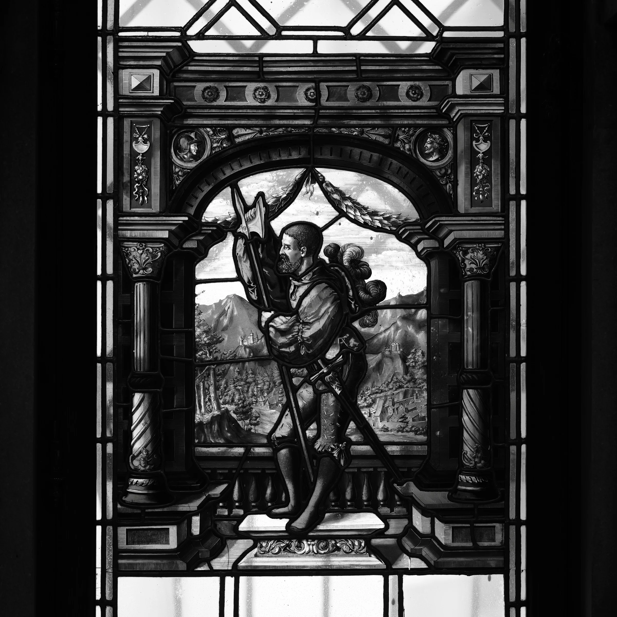 Black and white photo of stained glass depicting a knight at Peleș Castle